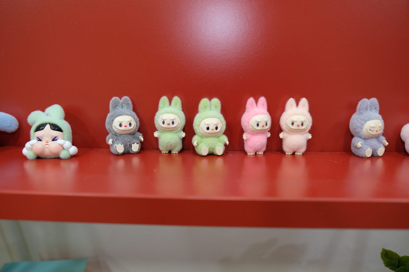 Toy figures on a red shelf